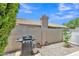 This backyard features a grill, stone ground cover, block wall, and well-kept landscaping at 6027 E Sayan Cir, Mesa, AZ 85215