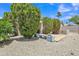 This backyard features mature landscaping, stone ground cover, and a patio area at 6027 E Sayan Cir, Mesa, AZ 85215
