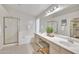 The primary bathroom has double sinks, a glass enclosed shower and separate tub at 6027 E Sayan Cir, Mesa, AZ 85215