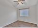 A secondary bedroom with wood-look flooring and a ceiling fan at 6027 E Sayan Cir, Mesa, AZ 85215