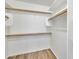 Walk-in closet with wood floors and white shelving at 6027 E Sayan Cir, Mesa, AZ 85215