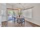 Cozy dining area featuring modern light fixtures, a round table, and access to the patio at 6027 E Sayan Cir, Mesa, AZ 85215