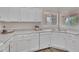 Bright kitchen featuring white cabinets, modern appliances, and sleek countertops at 6027 E Sayan Cir, Mesa, AZ 85215
