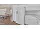 Bright kitchen area highlighting white cabinets, modern refrigerator, and breakfast nook at 6027 E Sayan Cir, Mesa, AZ 85215