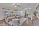 Comfortable living room with neutral tones, wood floors, and a ceiling fan at 6027 E Sayan Cir, Mesa, AZ 85215