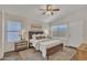 This bright main bedroom features a vaulted ceiling, a ceiling fan and a window with blinds at 6027 E Sayan Cir, Mesa, AZ 85215