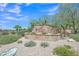 The Red Mountain Ranch community features a rock monument entrance and well-maintained landscaping at 6027 E Sayan Cir, Mesa, AZ 85215