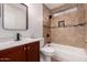 Updated bathroom featuring a shower-over-tub with tiled walls and a sleek vanity at 6038 W Gelding Dr, Glendale, AZ 85306