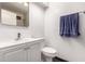 Clean bathroom with white vanity, modern fixtures, and a towel bar, providing a functional and stylish space at 6038 W Gelding Dr, Glendale, AZ 85306