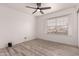 Inviting bedroom with wood-look floors and a bright window offering natural light at 6038 W Gelding Dr, Glendale, AZ 85306