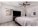Bright bedroom features wood-style floors, neutral paint, and a ceiling fan, creating a relaxing and comfortable space at 6038 W Gelding Dr, Glendale, AZ 85306