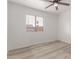 Bright bedroom features wood-style floors and ample natural light, creating a serene atmosphere perfect for relaxation at 6038 W Gelding Dr, Glendale, AZ 85306
