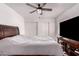 Inviting bedroom featuring neutral tones, ceiling fan, and wood-look floors, creating a cozy and stylish retreat at 6038 W Gelding Dr, Glendale, AZ 85306