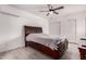 Spacious bedroom boasts a ceiling fan, wood-style floors and ample natural light, creating a serene atmosphere at 6038 W Gelding Dr, Glendale, AZ 85306