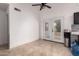 Eat-in dining area with tile flooring, bright white walls, and french doors with exterior access at 6038 W Gelding Dr, Glendale, AZ 85306
