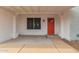 Inviting front porch with a red door and white pillars, complemented by a decorative window at 6038 W Gelding Dr, Glendale, AZ 85306