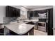 Charming kitchen featuring stainless appliances, a stylish backsplash, and a well-lit area, making it inviting at 6038 W Gelding Dr, Glendale, AZ 85306