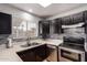 Well-designed kitchen featuring stainless steel appliances, modern backsplash, and practical layout for culinary enjoyment at 6038 W Gelding Dr, Glendale, AZ 85306