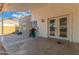 Covered patio area, perfect for outdoor entertaining, with a grill and access to the backyard at 6038 W Gelding Dr, Glendale, AZ 85306