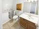 Bathroom featuring a walk-in tub, vanity with wood cabinets, toilet, and tile floors at 6617 W Cavedale Dr, Phoenix, AZ 85083
