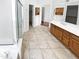 Bright bathroom featuring tile floors, vanity with wood cabinets, walk-in shower, and separate toilet room at 6617 W Cavedale Dr, Phoenix, AZ 85083