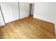 Bedroom with hardwood floors, white walls, double closets, and open doorway at 6617 W Cavedale Dr, Phoenix, AZ 85083