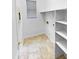 Functional laundry room with tile floors, shelving, and a window for ventilation at 6617 W Cavedale Dr, Phoenix, AZ 85083
