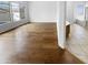 Open living area with hardwood floors, and two large windows that allow plenty of natural light to fill the room at 6617 W Cavedale Dr, Phoenix, AZ 85083