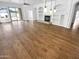 Spacious living room with hardwood flooring, built-in shelving, fireplace, and outdoor access at 6617 W Cavedale Dr, Phoenix, AZ 85083
