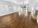 Spacious living room with hardwood floors, a ceiling fan, a fireplace, and sliding glass doors leading to the backyard at 6617 W Cavedale Dr, Phoenix, AZ 85083
