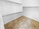 Walk-in closet with tiled floor and shelving, providing ample storage space at 6617 W Cavedale Dr, Phoenix, AZ 85083