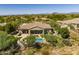 Aerial view of home featuring a swimming pool, backyard patio, lush landscaping, and mountain views at 6621 E Oberlin Way, Scottsdale, AZ 85266