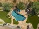 Aerial view of a backyard oasis featuring a sparkling pool, spa, fire pit, and lush desert landscaping at 6621 E Oberlin Way, Scottsdale, AZ 85266