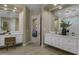 Contemporary bathroom with dual vanities, modern fixtures, neutral tones, and wood-look tile flooring at 6621 E Oberlin Way, Scottsdale, AZ 85266