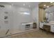Modern bathroom featuring a standalone tub, walk-in shower, sleek white tile, and updated vanity at 6621 E Oberlin Way, Scottsdale, AZ 85266