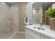 Elegant bathroom features a glass-enclosed shower, white cabinetry, marble countertops, and decorative mosaic tiles at 6621 E Oberlin Way, Scottsdale, AZ 85266