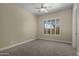 Simple bedroom with carpet flooring, ceiling fan, and windows with plantation shutters at 6621 E Oberlin Way, Scottsdale, AZ 85266