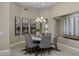 Inviting dining room with a round table, elegant chandelier, and decorative artwork at 6621 E Oberlin Way, Scottsdale, AZ 85266