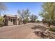 Neighborhood entrance with stone gatehouse and well-maintained landscaping at 6621 E Oberlin Way, Scottsdale, AZ 85266