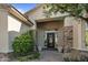 Charming front entrance with stone accents, decorative door, potted plants, and a welcoming walkway at 6621 E Oberlin Way, Scottsdale, AZ 85266