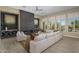 Cozy living room featuring a modern fireplace, large windows with plantation shutters, and comfortable seating at 6621 E Oberlin Way, Scottsdale, AZ 85266