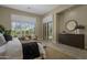 Serene main bedroom with plantation shutters, a decorative mirror, and a tranquil sitting area for relaxation at 6621 E Oberlin Way, Scottsdale, AZ 85266
