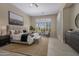 Serene main bedroom with neutral tones, plantation shutters, tile floors, and ample natural light at 6621 E Oberlin Way, Scottsdale, AZ 85266