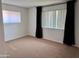A spacious, carpeted bedroom is flooded with natural light at 700 W University Dr # 203, Tempe, AZ 85281