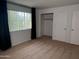A spacious, carpeted bedroom is flooded with natural light and a closet at 700 W University Dr # 203, Tempe, AZ 85281