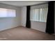 A spacious, carpeted bedroom is flooded with natural light at 700 W University Dr # 203, Tempe, AZ 85281