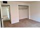 A well-lit bedroom features neutral carpeting and a spacious closet, offering comfort and storage at 700 W University Dr # 203, Tempe, AZ 85281