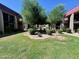 Beautifully landscaped community green with mature trees and a decorative water feature for a welcoming outdoor ambiance at 700 W University Dr # 203, Tempe, AZ 85281
