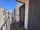 Balcony and entryway to a unit with black security door and a wooden porch at 700 W University Dr # 203, Tempe, AZ 85281
