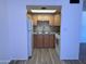 Galley kitchen with wood cabinets, tile backsplash, and appliances, maximizing space and functionality at 700 W University Dr # 203, Tempe, AZ 85281